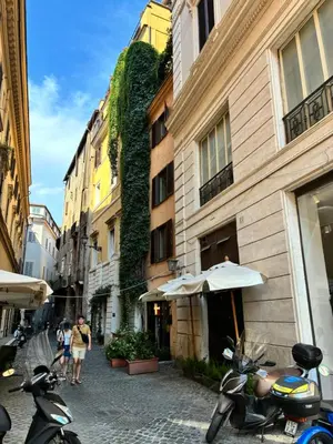 a group of motorcycles parked on a street next to buildings at Domus Antica Navona in Rome