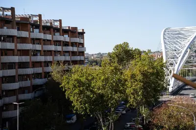 a large apartment building and a roller coaster at Garbatella Bridge Apartment in Rome