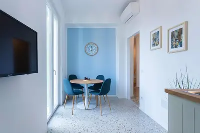 a dining room with blue walls and a table and chairs at Flora Cozy Flat close to Metro in Rome