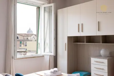 a room with a window and a bed and a window at Giglio Dome View - St Peter View, 300mt to Metro A, Vatican City, A-C in Rome