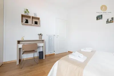a bedroom with a desk and a bed and a chair at Giglio Dome View - St Peter View, 300mt to Metro A, Vatican City, A-C in Rome