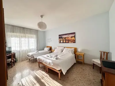 a white bedroom with a bed and a couch at A Casa di Gio in Rome