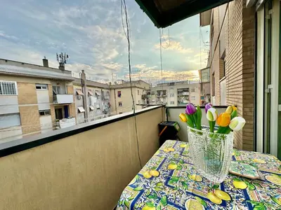 a vase of flowers sitting on a table on a balcony at A Casa di Gio in Rome
