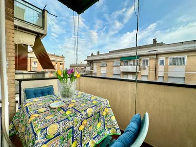 a table with a vase of flowers on a balcony at A Casa di Gio in Rome