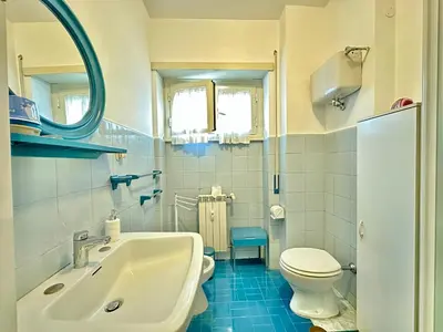 a bathroom with a sink and a toilet and a mirror at A Casa di Gio in Rome