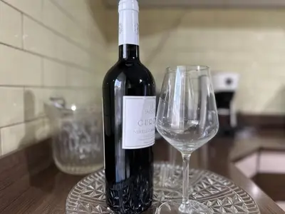 a bottle of wine sitting next to a wine glass at A Casa di Gio in Rome
