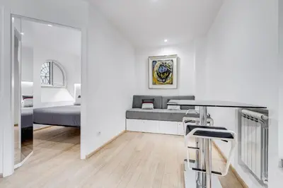 a white room with a bed and a mirror at Colosseum Charming Suite monti district with jacuzzi in Rome