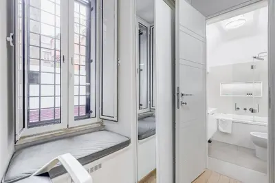 a bathroom with a window seat and a sink at Colosseum Charming Suite monti district with jacuzzi in Rome