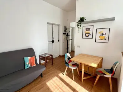 a living room with a couch and a table and chairs at Casa degli Effetti in Rome