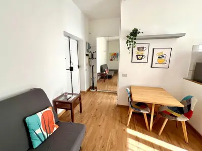 a living room with a wooden table and chairs at Casa degli Effetti in Rome