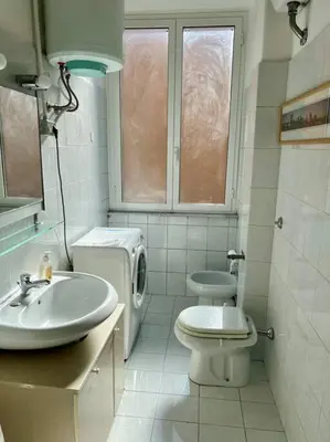 a bathroom with a toilet and a sink at Casa degli Effetti in Rome