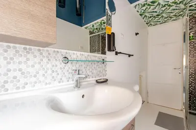 a bathroom with a white sink and a shower at Casa Cornelia 10 MIN to metro, near Vatican in Rome