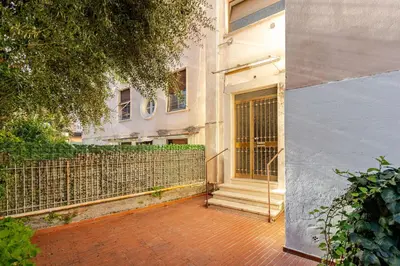 a house with a wooden door and a fence at Casa Cornelia 10 MIN to metro, near Vatican in Rome