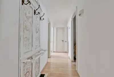a hallway with white walls and a large white door at Elle House in Rome