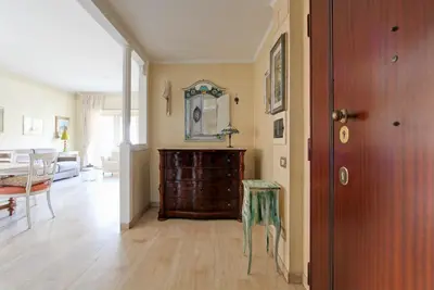 a living room with a table and a dining room at Elle House in Rome