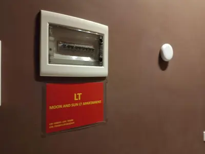 a microwave and safe on the wall of a room at Moon and Sun LT Apartament in Rome