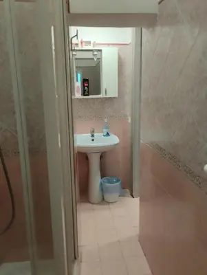 a bathroom with a sink and a mirror at Moon and Sun LT Apartament in Rome