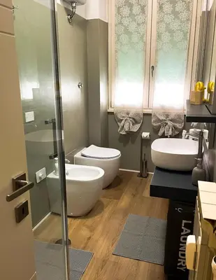 a bathroom with two sinks and a toilet and a shower at Viale4Venti in Rome
