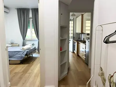 a small bedroom with a bed and a kitchen at Viale4Venti in Rome