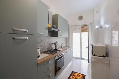 a white kitchen with a stove and a refrigerator at We Home - La Dimora di Portonaccio - Roma in Rome