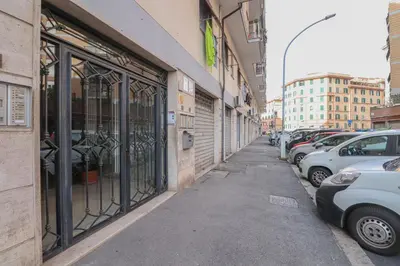 a street with cars parked on the side of a building at We Home - La Dimora di Portonaccio - Roma in Rome
