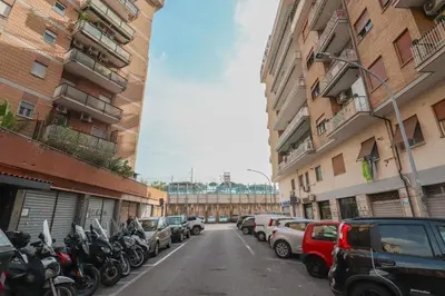 a street with cars and motorcycles parked on the street at We Home - La Dimora di Portonaccio - Roma in Rome