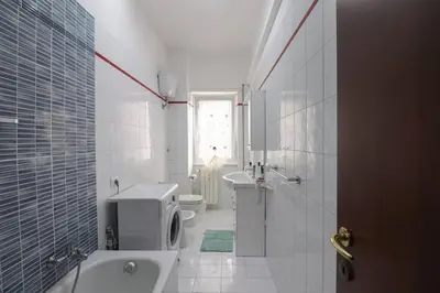 a white bathroom with a toilet and a sink at We Home - La Dimora di Portonaccio - Roma in Rome