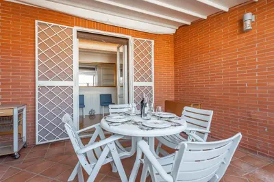 a white table and chairs on a patio at Monteverde 2BDR Penthouse in Rome