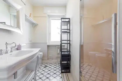 a bathroom with a sink and a ladder to a shower at Monteverde 2BDR Penthouse in Rome
