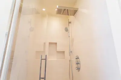 a shower stall in a bathroom with a shower at Monteverde 2BDR Penthouse in Rome