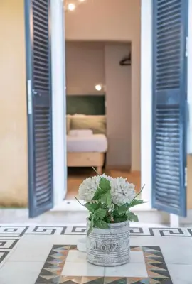 a vase with flowers on a table in a living room at Domus Augustea - 3 Floor in Rome