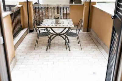a table and chairs sitting on a balcony at Domus Augustea - 3 Floor in Rome