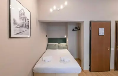 a small bedroom with a bed in a room at Domus Augustea - 3 Floor in Rome
