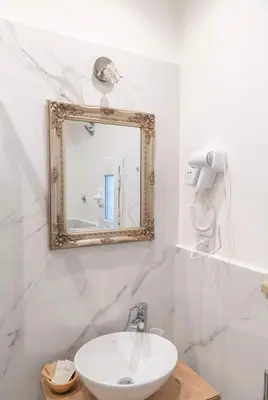a bathroom with a sink and a mirror at Domus Augustea - 3 Floor in Rome