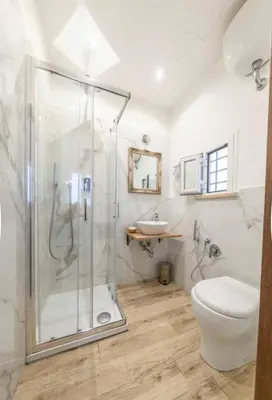 a bathroom with a shower and a toilet and a sink at Domus Augustea - 3 Floor in Rome