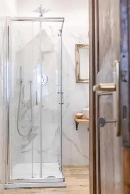a shower with a glass door in a bathroom at Domus Augustea - 3 Floor in Rome