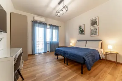 a bedroom with a bed and a large window at Lorena Cozy Rooms - Ospedale Gemelli - WiFi in Rome