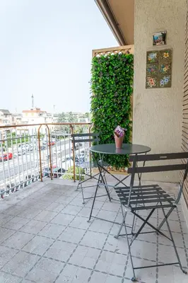 a table and chairs sitting on a balcony at Lorena Cozy Rooms - Ospedale Gemelli - WiFi in Rome