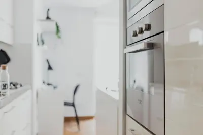 a kitchen with a glass refrigerator and a chair at Photographer's House in Rome