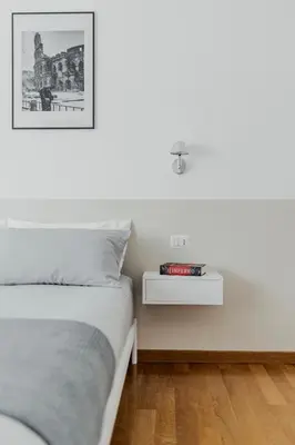 a bedroom with a bed and a side table at Photographer's House in Rome