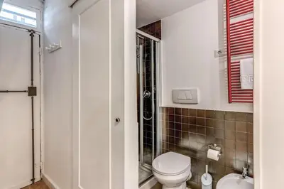 a bathroom with a toilet and a glass shower at Fresh House San Lorenzo in Rome