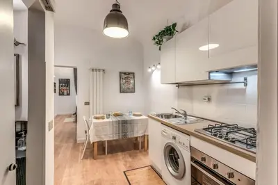 a kitchen with a sink and a washing machine at Fresh House San Lorenzo in Rome