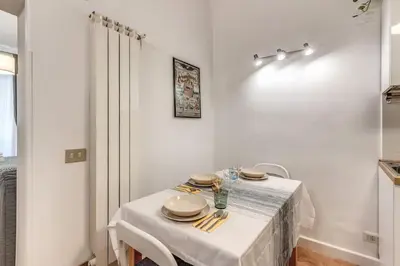 a white table with a white table cloth on it at Fresh House San Lorenzo in Rome