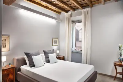 a bedroom with a white bed and a window at Appartamento Roma Coronari Suite in Rome