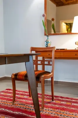 a wooden table with a chair and a desk at Appartamento Roma Coronari Suite in Rome