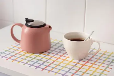 a tea pot and a cup of coffee on a counter at Appartamento di Design - Metro Re di Roma in Rome