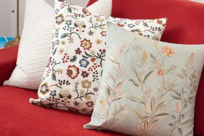 two pillows are sitting on a red couch at Appartamento di Design - Metro Re di Roma in Rome