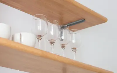 a group of wine glasses on a shelf at Appartamento di Design - Metro Re di Roma in Rome