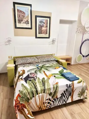 a bedroom with a bed with a colorful comforter at Happy Days \u5feb\u4e50\u7684\u65e5\u5b50 in Rome
