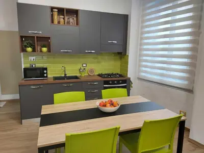a kitchen with a table with a bowl of fruit on it at Happy Days \u5feb\u4e50\u7684\u65e5\u5b50 in Rome